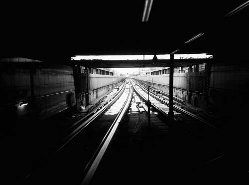 train track grayscale photography of subway track railway